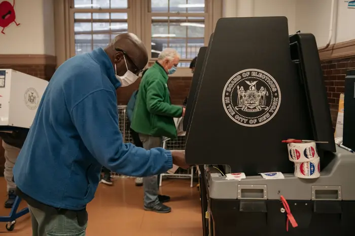 Man at a booth during Election Day voting, November 2021.